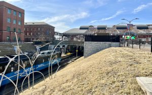 MetroLink train arriving at Union Station with the Aquarium and Wheel showing in the background